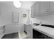Well-organized laundry room equipped with a sink, washer, dryer, and storage shelves at 2941 Forest Park Dr, Charlotte, NC 28209