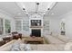 Bright living room with modern chandelier, fireplace with TV, and built-in bookcases at 2941 Forest Park Dr, Charlotte, NC 28209