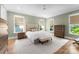 Spacious main bedroom featuring neutral walls, hardwood floors, and a cozy sitting area by the window at 2941 Forest Park Dr, Charlotte, NC 28209