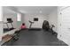 Basement workout room with ample exercise equipment and wall-mounted TV at 2941 Forest Park Dr, Charlotte, NC 28209