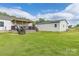 Backyard featuring a covered deck connecting house to a large detached garage and wooded views at 326 Teeter Rd, Mooresville, NC 28115