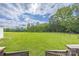 Expansive backyard featuring a lush green field, bordered by a wooden fence and mature trees at 326 Teeter Rd, Mooresville, NC 28115