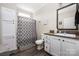 Well-lit bathroom with modern fixtures, storage cabinets, and shower with decorative curtain at 326 Teeter Rd, Mooresville, NC 28115