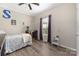 Cozy bedroom with decorative ceiling fan, hardwood floors, and window with natural light at 326 Teeter Rd, Mooresville, NC 28115