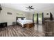 Spacious bedroom featuring wood-look floors, a ceiling fan, and natural light, creating a peaceful retreat at 326 Teeter Rd, Mooresville, NC 28115