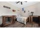 Charming bedroom with hardwood floors, ceiling fan, and rustic wood accent furniture at 326 Teeter Rd, Mooresville, NC 28115