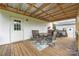 Relaxing covered deck with table, chairs, and outdoor lighting for cozy evenings at 326 Teeter Rd, Mooresville, NC 28115