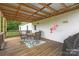 Charming covered deck featuring a table with chairs and a fun swing for outdoor enjoyment at 326 Teeter Rd, Mooresville, NC 28115