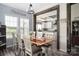 Bright dining room featuring a wooden table, white chairs, natural light, and an open view to the kitchen at 326 Teeter Rd, Mooresville, NC 28115