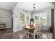 Sunlit dining room with a wood table, white chairs, and views of the outdoor landscape at 326 Teeter Rd, Mooresville, NC 28115