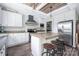 Well-appointed kitchen with white cabinets, wood countertops, an island with seating and stainless steel appliances at 326 Teeter Rd, Mooresville, NC 28115