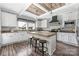 Bright kitchen features white cabinetry, wood-look floors, modern appliances and a central island with seating at 326 Teeter Rd, Mooresville, NC 28115