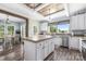 Stylish kitchen with white cabinets, stainless steel appliances, a wood-topped island and a view into the dining room at 326 Teeter Rd, Mooresville, NC 28115