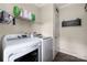 Well-lit laundry room with newer washer and dryer, shelving, and decorative chalkboard accent at 326 Teeter Rd, Mooresville, NC 28115