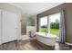 Bright and spacious bathroom featuring a modern soaking tub, shower, and double sink vanity at 326 Teeter Rd, Mooresville, NC 28115