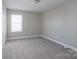 Carpeted bedroom with a window, overhead lighting, and a spacious closet at 4117 Sunset Ridge Dr, Rock Hill, SC 29732