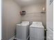 Functional laundry area equipped with standard washer and dryer units and wire rack shelving at 4117 Sunset Ridge Dr, Rock Hill, SC 29732
