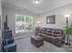 Comfortable living room with a leather sofa and natural light streaming through the window at 4117 Sunset Ridge Dr, Rock Hill, SC 29732