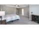 Spacious main bedroom featuring neutral walls, carpet, tray ceiling, and access to the main bathroom at 4117 Sunset Ridge Dr, Rock Hill, SC 29732