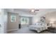 Bright main bedroom featuring neutral walls, carpet, ceiling fan, tray ceiling, and large windows providing lots of natural light at 4117 Sunset Ridge Dr, Rock Hill, SC 29732