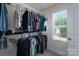 Well-organized walk-in closet with shelves and rods offering ample storage space and natural light from the window at 4117 Sunset Ridge Dr, Rock Hill, SC 29732