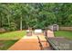 Spacious backyard with a patio, outdoor seating, lush greenery, and a storage shed at 4502 Magnolia Ridge Dr, Waxhaw, NC 28173