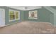 Spacious bedroom with neutral carpet, offering ample natural light from the two large windows at 4502 Magnolia Ridge Dr, Waxhaw, NC 28173