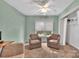 Cozy bedroom featuring a ceiling fan, two comfortable chairs, and a closet for ample storage space at 4502 Magnolia Ridge Dr, Waxhaw, NC 28173