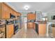 A well-lit kitchen featuring stainless appliances, granite countertops and tile backsplash at 4502 Magnolia Ridge Dr, Waxhaw, NC 28173