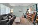 Comfortable living room with tile floors, leather sofa, and musical instruments at 4502 Magnolia Ridge Dr, Waxhaw, NC 28173