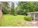 An expansive backyard features mature trees, a lush lawn, and a shed, perfect for outdoor activities and relaxation at 4533 Gainesborough Rd, Charlotte, NC 28205