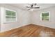 Bright bedroom with two windows, ceiling fan, and hardwood flooring at 4533 Gainesborough Rd, Charlotte, NC 28205