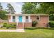 Charming brick home with a bright turquoise front door and white trim at 4533 Gainesborough Rd, Charlotte, NC 28205
