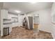 Updated kitchen with white cabinets, stainless steel appliances, and modern flooring at 4533 Gainesborough Rd, Charlotte, NC 28205