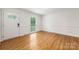 Bright living room with hardwood floors, large window, and white trim at 4533 Gainesborough Rd, Charlotte, NC 28205