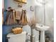 Cozy bathroom featuring a pedestal sink, decorative towels, and a toilet with stylish accessories at 4916 Oak Pasture Ln, Charlotte, NC 28269