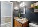 Bathroom featuring a stylish vanity with decorative accents and modern lighting at 4916 Oak Pasture Ln, Charlotte, NC 28269