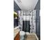 Bathroom view showcasing the shower with a themed shower curtain and built-in shelving at 4916 Oak Pasture Ln, Charlotte, NC 28269