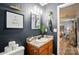 Bathroom featuring a dark painted wall, vanity with granite countertop, and plants at 4916 Oak Pasture Ln, Charlotte, NC 28269