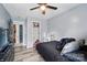 Bedroom with wood-look floors, ceiling fan, and large walk-in closet at 4916 Oak Pasture Ln, Charlotte, NC 28269