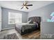 Bedroom featuring wood-look floors, a bed, a window with blinds and neutral walls at 4916 Oak Pasture Ln, Charlotte, NC 28269