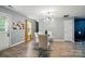 Bright dining room boasts a glass table with seating and modern lighting at 4916 Oak Pasture Ln, Charlotte, NC 28269