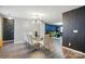 Dining room features a glass table and seating, with open access to the living room at 4916 Oak Pasture Ln, Charlotte, NC 28269