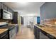 View from kitchen showing stainless steel appliances and open concept to dining area at 4916 Oak Pasture Ln, Charlotte, NC 28269