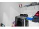 Laundry room with modern washer and dryer set and built-in shelving at 4916 Oak Pasture Ln, Charlotte, NC 28269