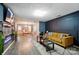 Stylish living room boasts hardwood floors, modern lighting, and contemporary decor with lots of open space at 4916 Oak Pasture Ln, Charlotte, NC 28269