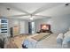 Spacious main bedroom featuring wood flooring, modern ceiling fan, and flat screen television at 4916 Oak Pasture Ln, Charlotte, NC 28269