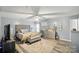 Spacious main bedroom with wood flooring, a king bed, ceiling fan, and neutral color palette at 4916 Oak Pasture Ln, Charlotte, NC 28269
