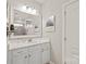 Bright bathroom featuring white cabinets, quartz countertops, and a large framed mirror at 5002 Samoa Ridge Dr, Lancaster, SC 29270
