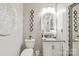 Chic powder room featuring unique wall decor, a modern vanity, and a stylish mirror at 5002 Samoa Ridge Dr, Lancaster, SC 29270